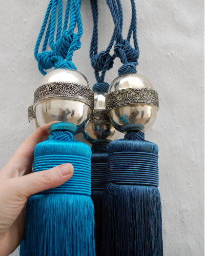 Small Boukala tassels and curtain tie backs with hand engraved oval silver metal motif handmade in Morocco